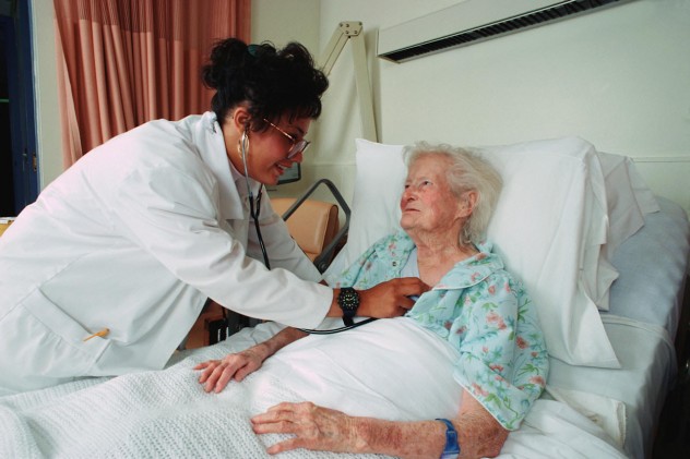 Doctor listening to an elderly patient's heartbeat with a stethoscope