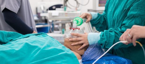 Surgeons preparing a procedure on a patient's airway